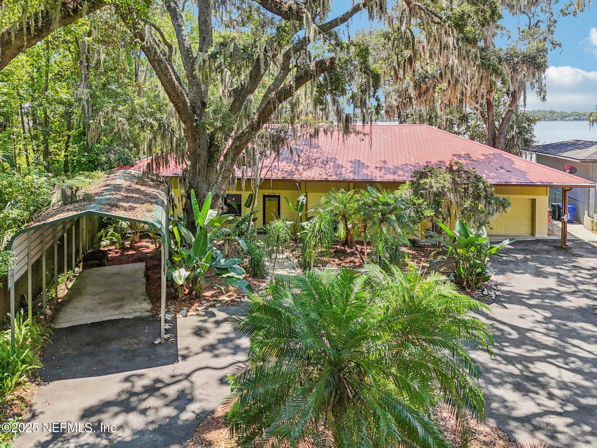2778 Holly Point Road West Orange Park, FL 32073 - Photo 20 of 68 a front view of a house with a yard