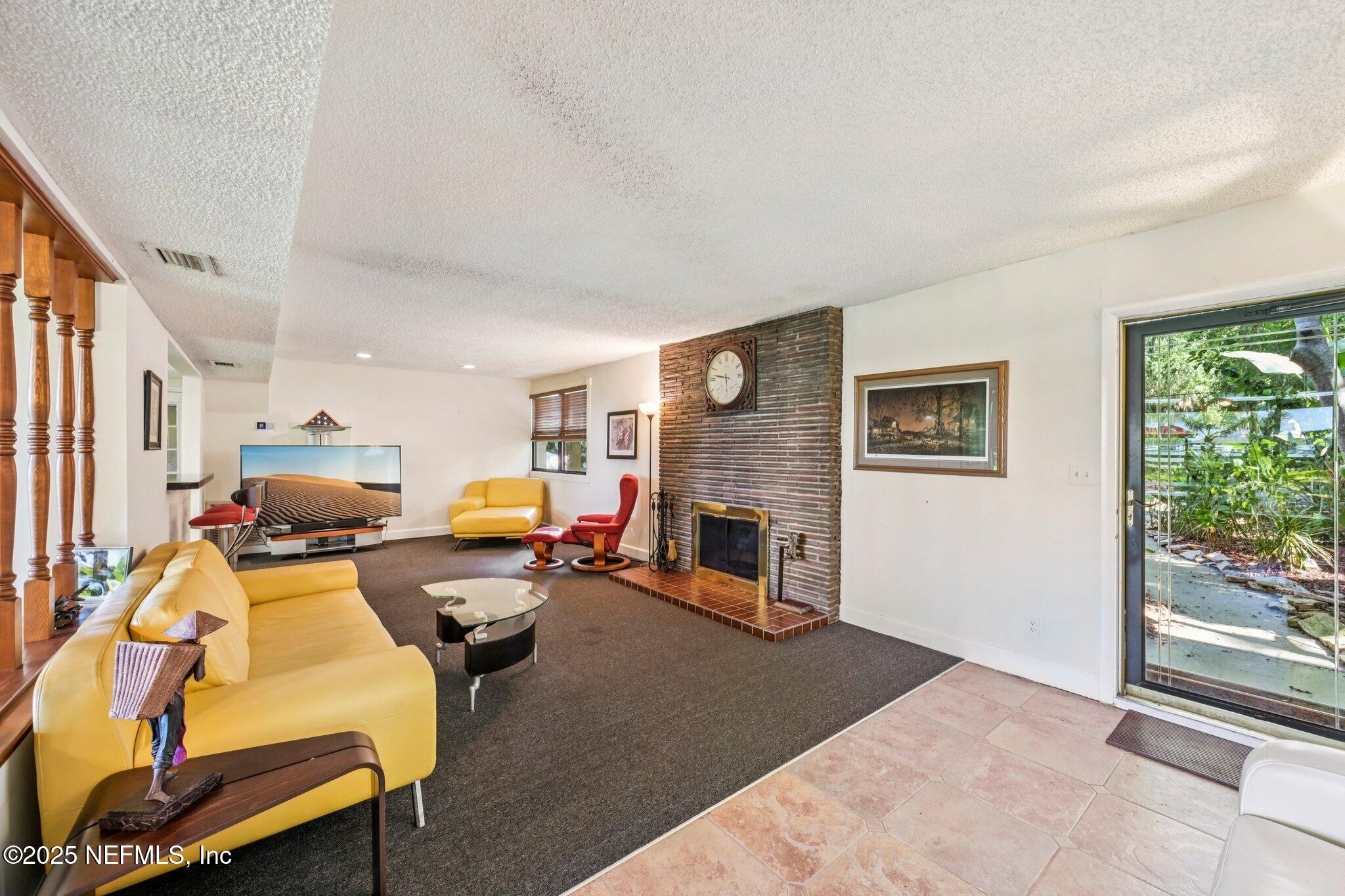 2778 Holly Point Road West Orange Park, FL 32073 - Photo 26 of 68 a living room with furniture and a fireplace