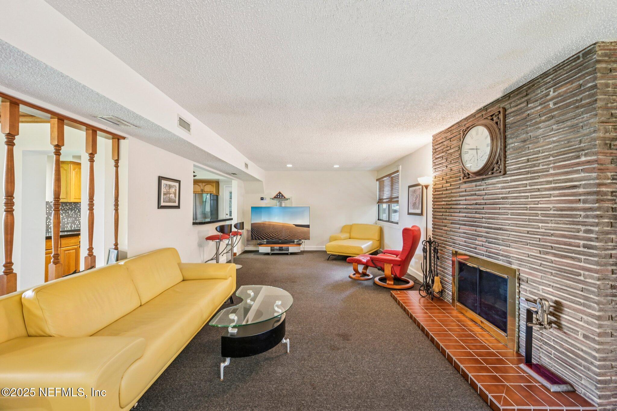 2778 Holly Point Road West Orange Park, FL 32073 - Photo 27 of 68 a living room with furniture flat screen tv and a fireplace
