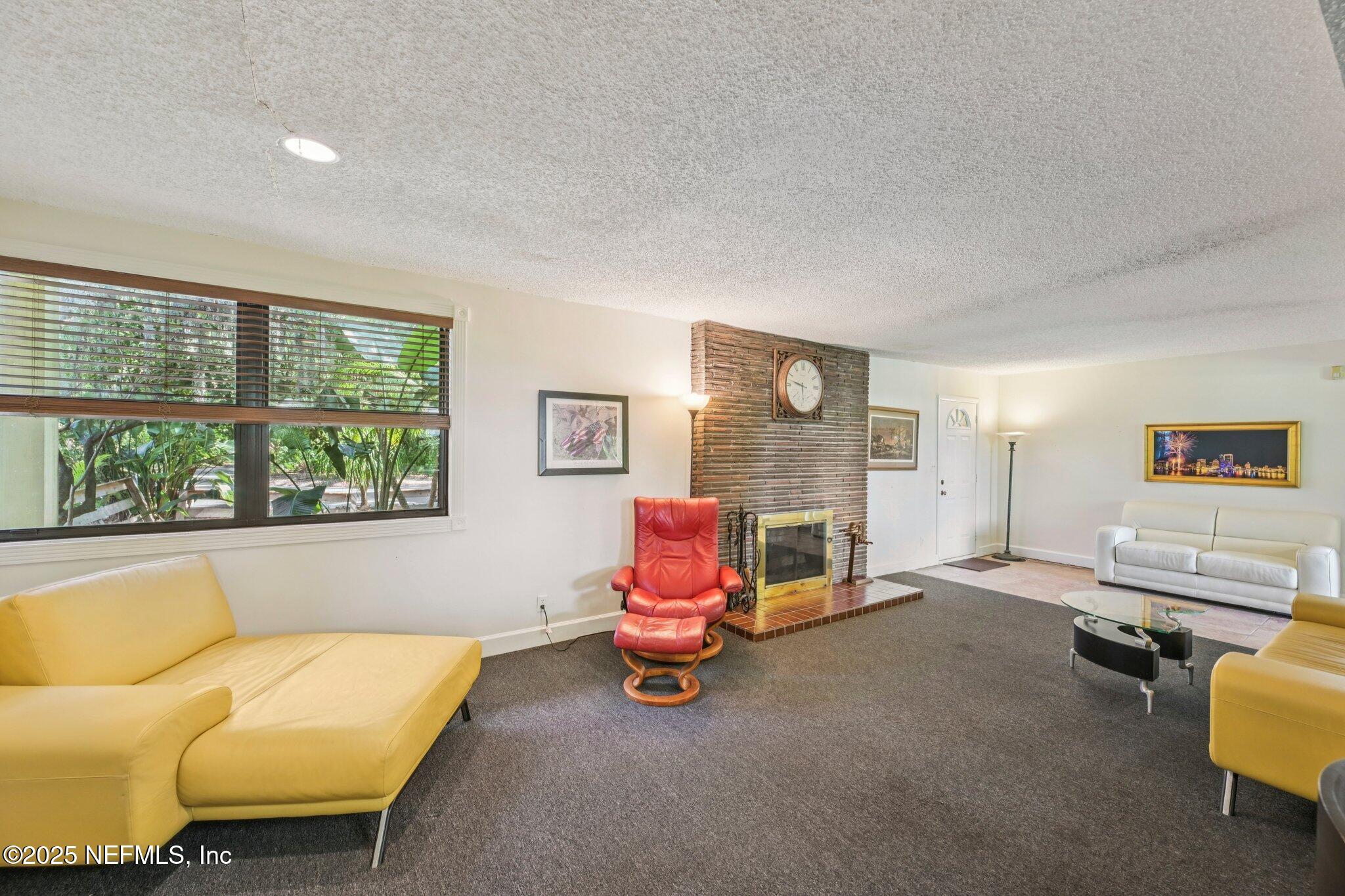 2778 Holly Point Road West Orange Park, FL 32073 - Photo 28 of 68 a living room with furniture ceiling fan and a window