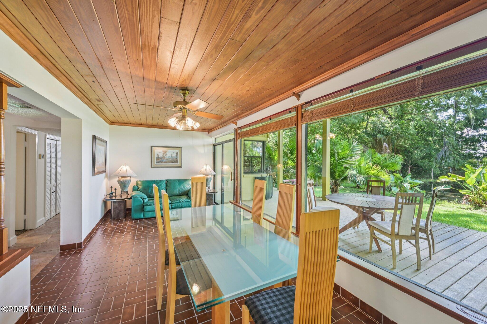 2778 Holly Point Road West Orange Park, FL 32073 - Photo 33 of 68 a view of a dining room with furniture large windows and wooden floor