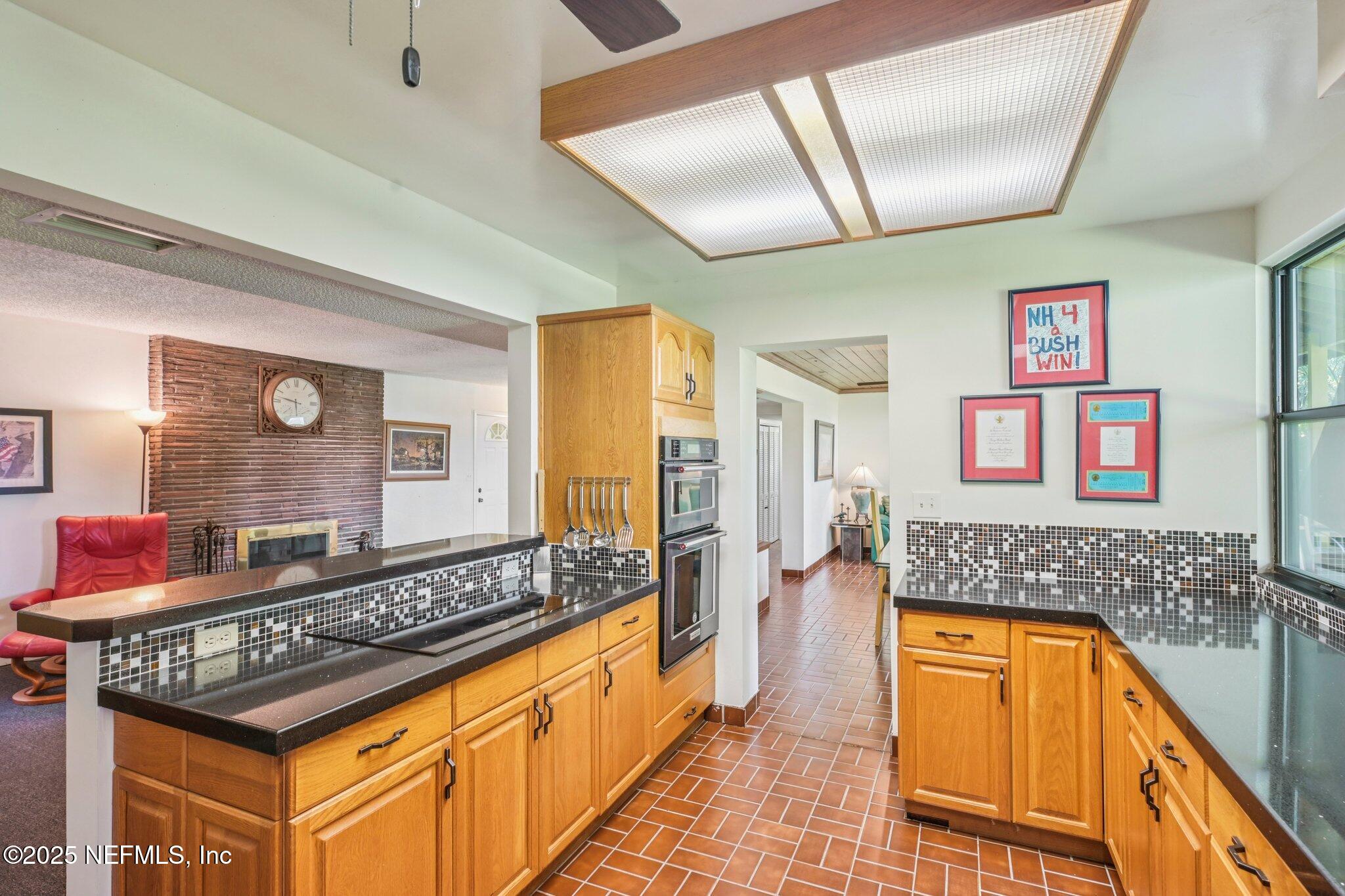 2778 Holly Point Road West Orange Park, FL 32073 - Photo 37 of 68 a spacious bathroom with a granite countertop tub sink a mirror and a shower