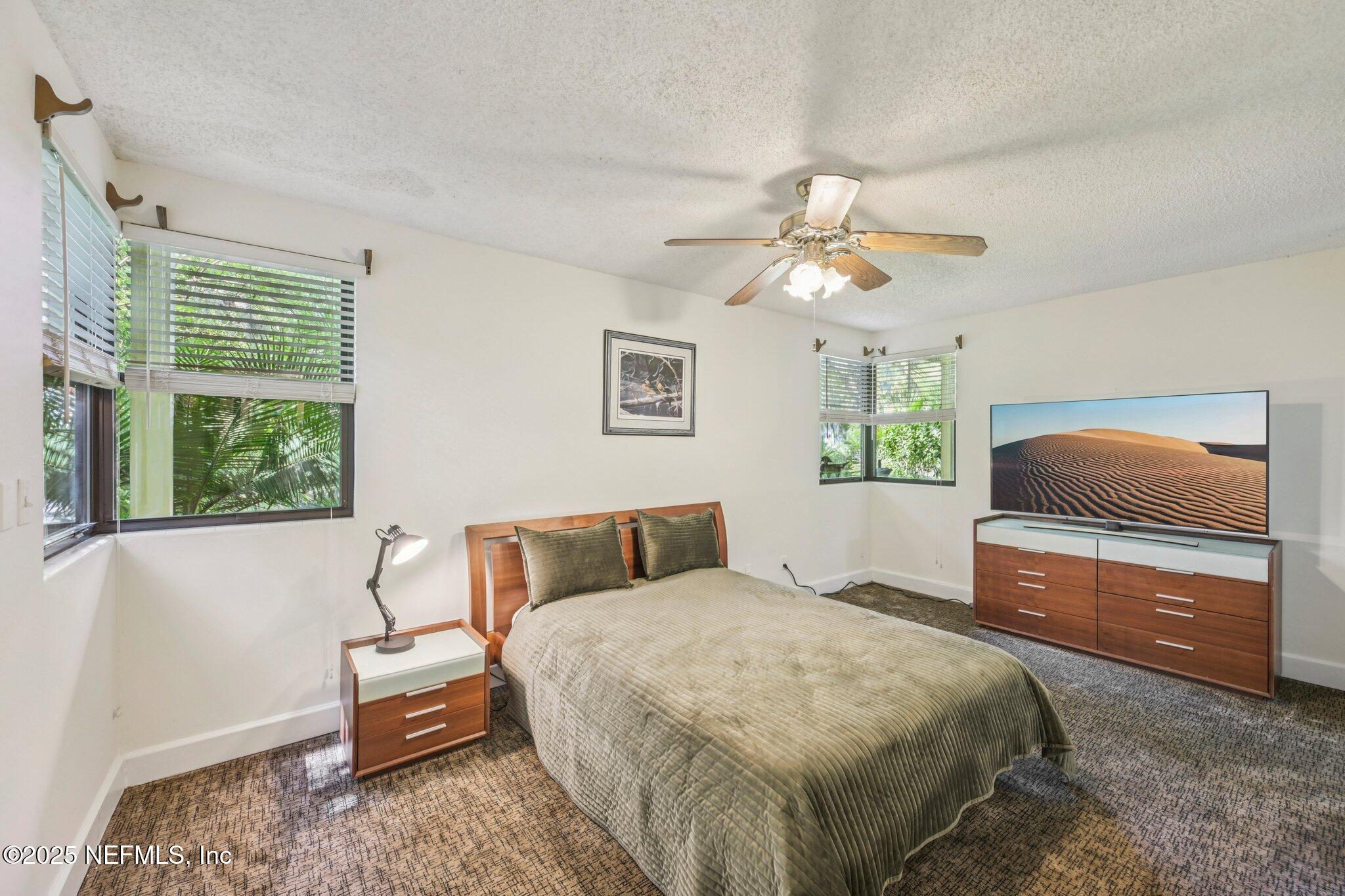 2778 Holly Point Road West Orange Park, FL 32073 - Photo 44 of 68 a bedroom with a bed and a chandelier