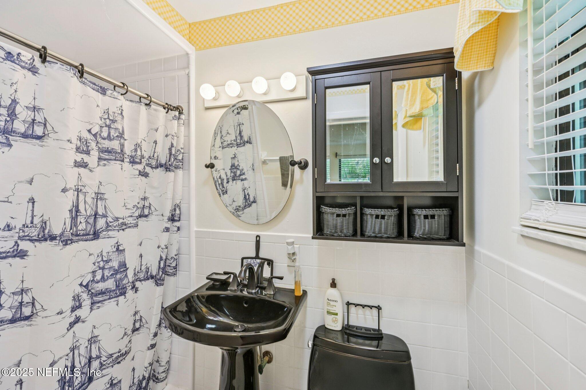 2778 Holly Point Road West Orange Park, FL 32073 - Photo 46 of 68 a bathroom with a sink and a mirror