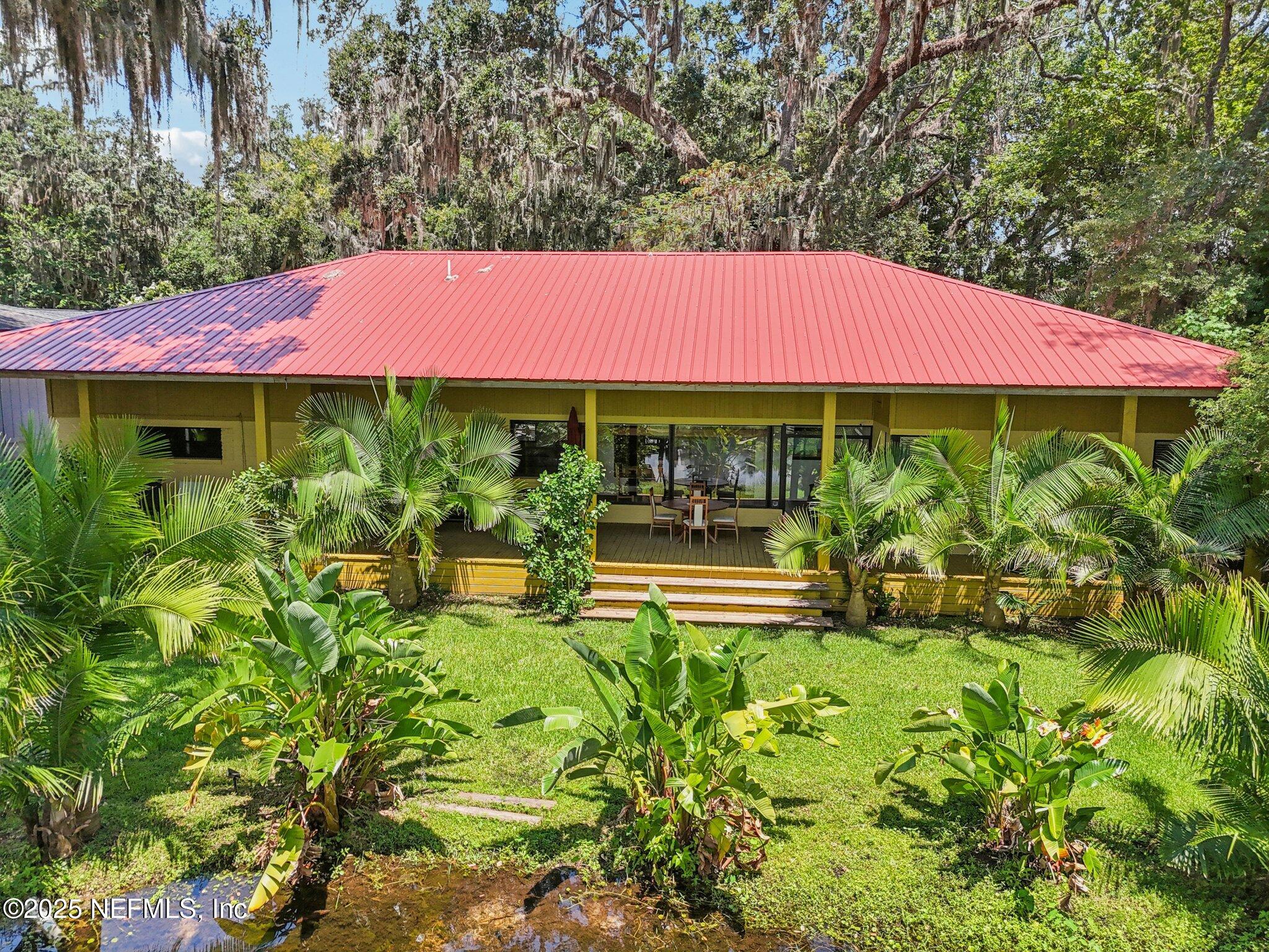 2778 Holly Point Road West Orange Park, FL 32073 - Photo 47 of 68 a view of a house with swimming pool garden and patio
