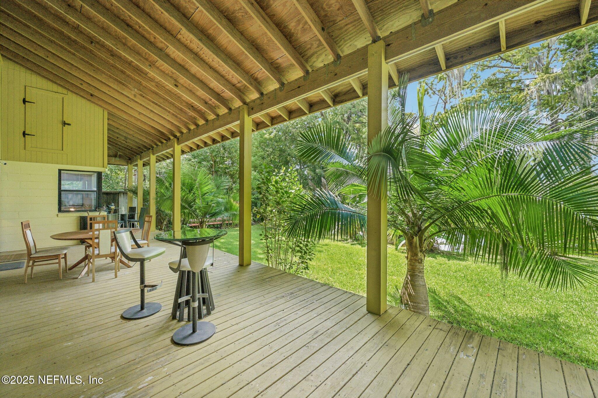 2778 Holly Point Road West Orange Park, FL 32073 - Photo 50 of 68 a view of a patio with table and chairs and wooden floor