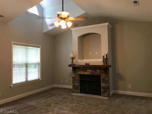 111 Powers Road Winston-Salem, NC 27106 - Photo 11 of 22 Gas Fireplace with 'rock' front and nice mantel add a focal point to the living room