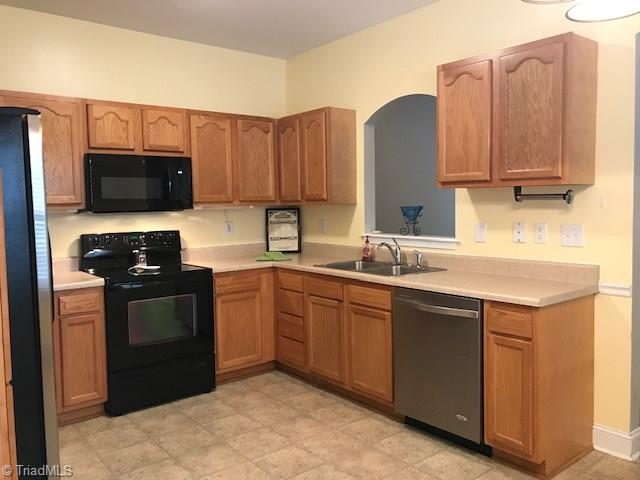 111 Powers Road Winston-Salem, NC 27106 - Photo 3 of 22 Nice appliance, undercounter lighting, new microwave plus an arched opening for interacting with family and friends while preparing meals