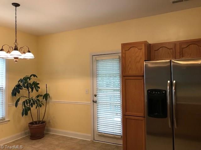 111 Powers Road Winston-Salem, NC 27106 - Photo 4 of 22 Breakfast area is cheerful with easy access to deck as well as living room