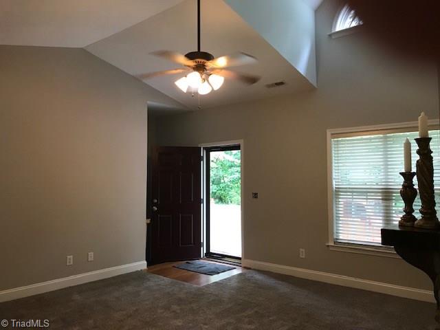 111 Powers Road Winston-Salem, NC 27106 - Photo 10 of 22 Angled ceiling with arched window up high provide interest and detail to your living room