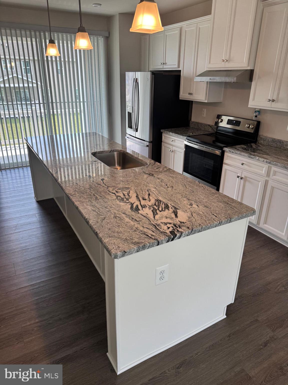 160 Torrey Drive Newark, DE 19702 - Photo 3 of 36 a kitchen with granite countertop wooden cabinets a stove top oven a sink and dishwasher