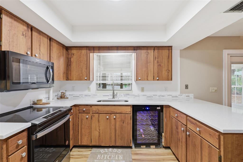 244 Angeles Road DeBary, FL 32713 - Photo 18 of 41 a kitchen with a sink stove top oven and cabinets