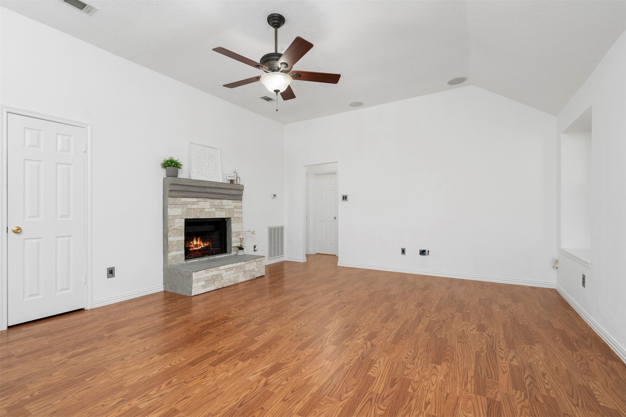 22835 Sherioaks Lane Spring, TX 77389 - Photo 3 of 12 The large open living area has laminate floors which are easy to keep clean, a cozy fireplace and a ceiling fan.