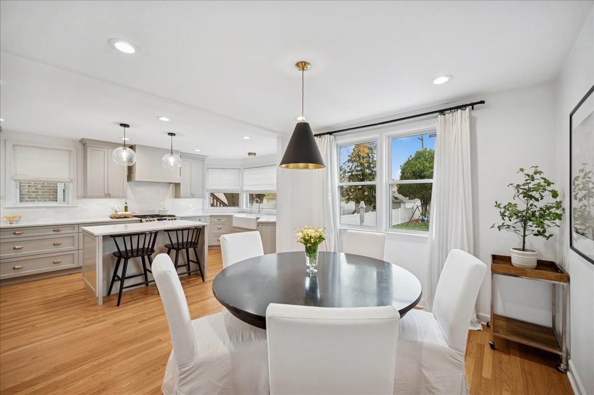 821 Lathrop Avenue Forest Park, IL 60130 - Photo 13 of 38 a dining room with furniture potted plants and wooden floor