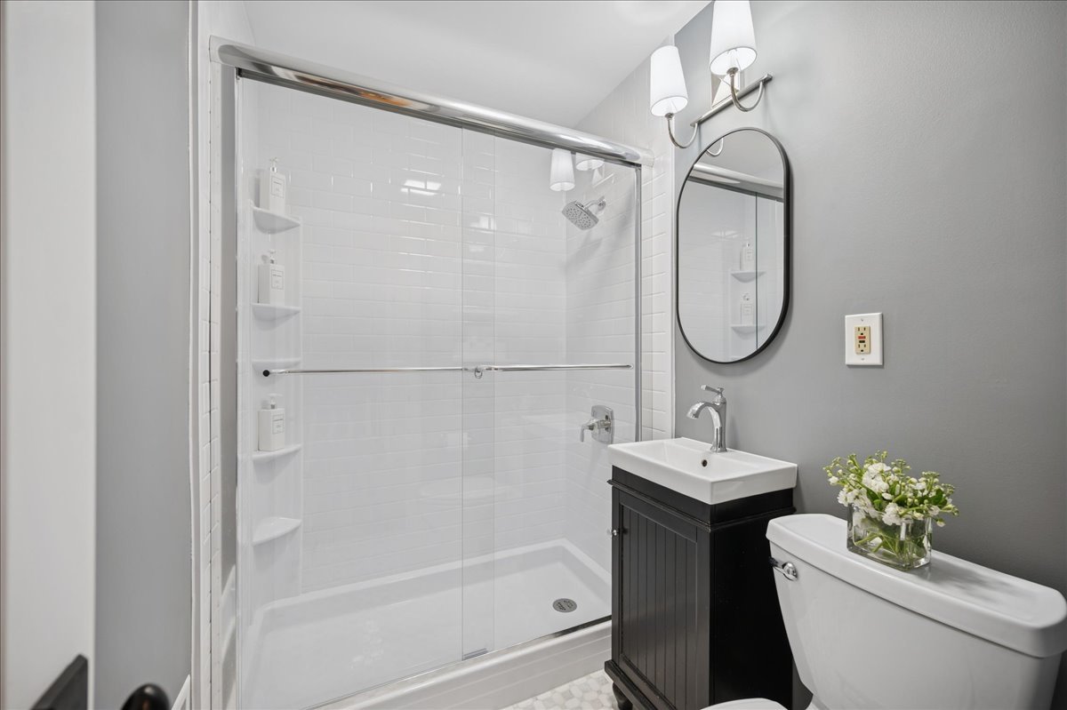 821 Lathrop Avenue Forest Park, IL 60130 - Photo 16 of 38 a bathroom with a sink a toilet and shower