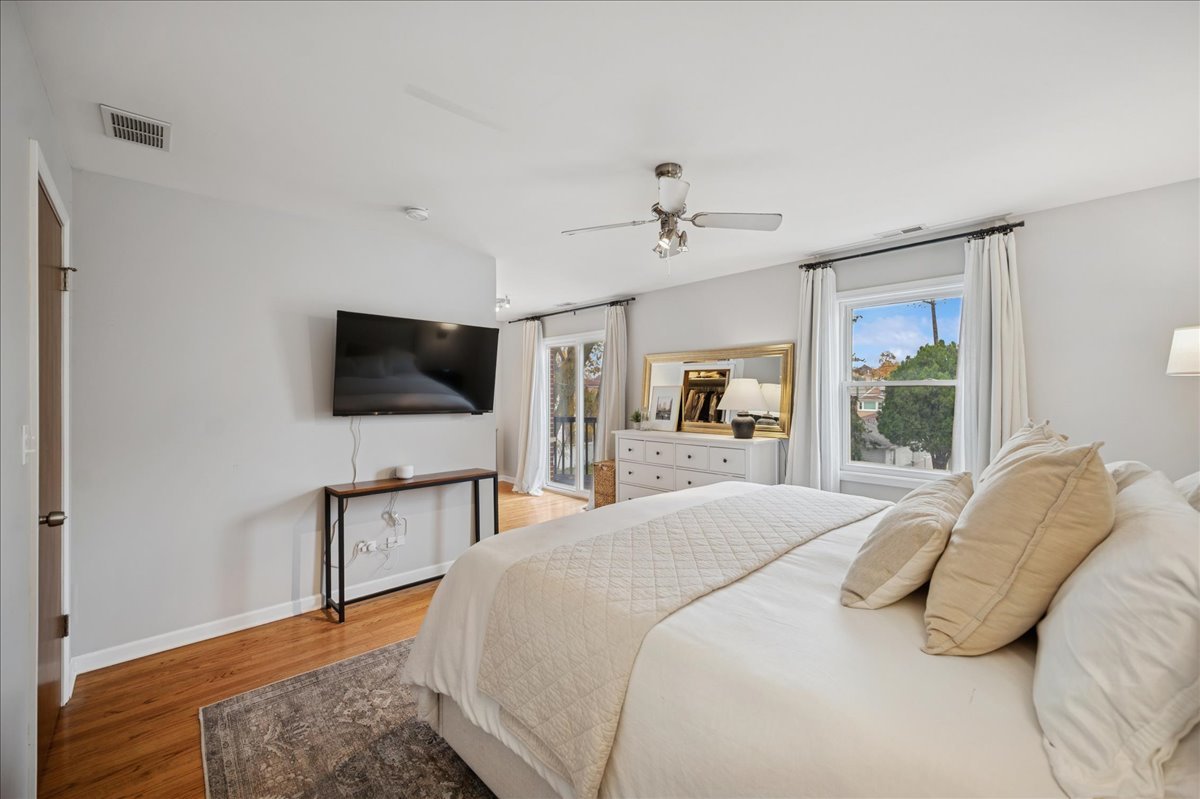 821 Lathrop Avenue Forest Park, IL 60130 - Photo 18 of 38 a bedroom with a bed and a flat screen tv