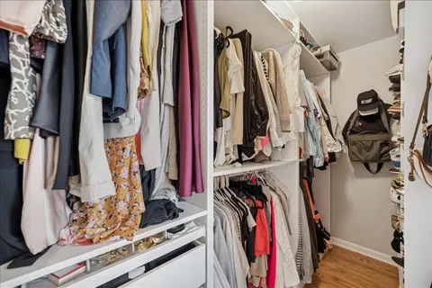 a view of walk in closet with clothes