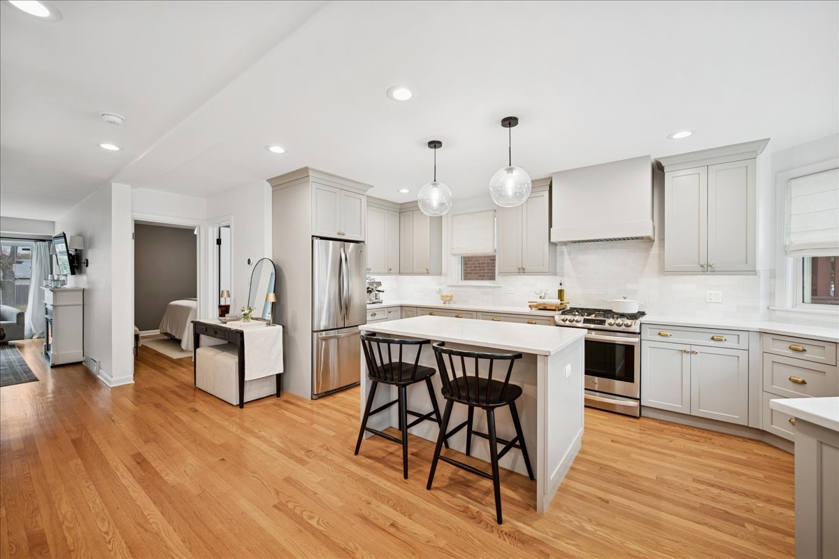 821 Lathrop Avenue Forest Park, IL 60130 - Photo 8 of 38 a kitchen with stainless steel appliances a stove a sink dishwasher a refrigerator with white cabinets and wooden floor