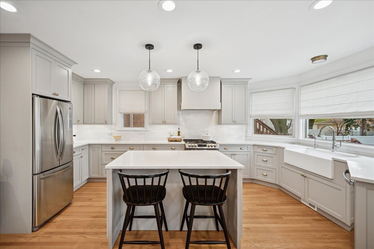 821 Lathrop Avenue Forest Park, IL 60130 - Photo 9 of 38 a kitchen with kitchen island granite countertop a sink a center island and stainless steel appliances