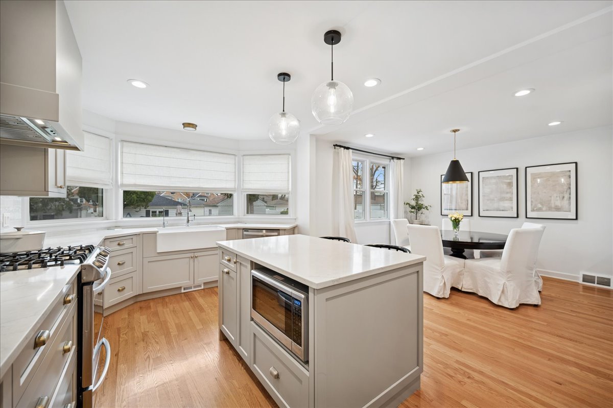 821 Lathrop Avenue Forest Park, IL 60130 - Photo 10 of 38 a kitchen that has a sink a stove and chairs
