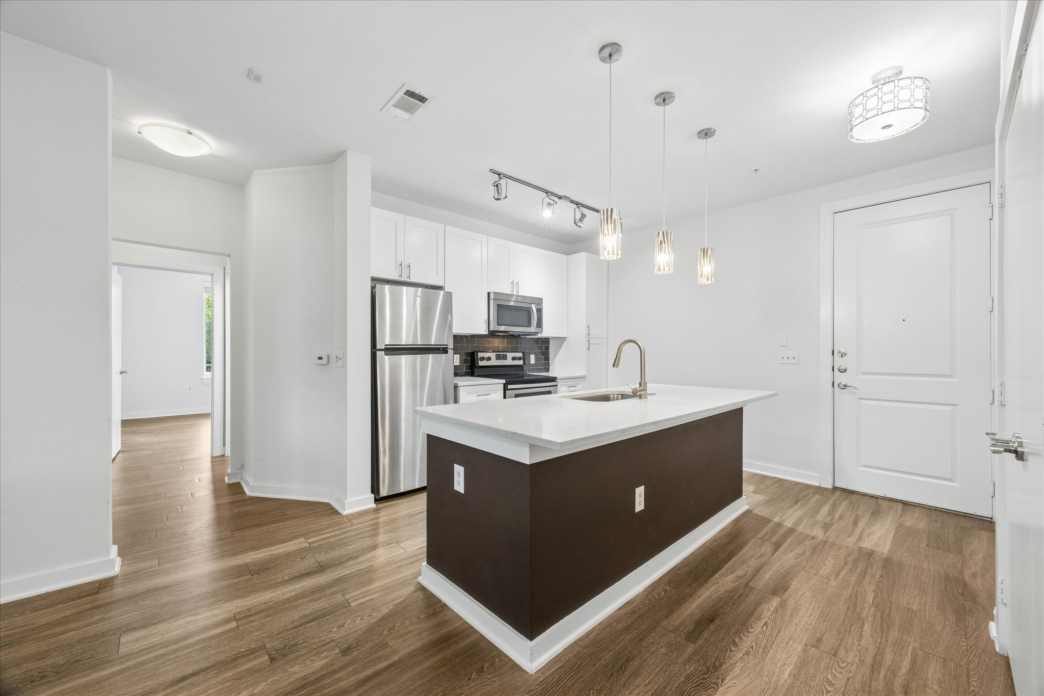 1900 Barton Springs Road, Unit 4041 Austin, TX 78704 - Photo 12 of 35 Modern kitchen with an inviting island and sleek stainless steel appliances.