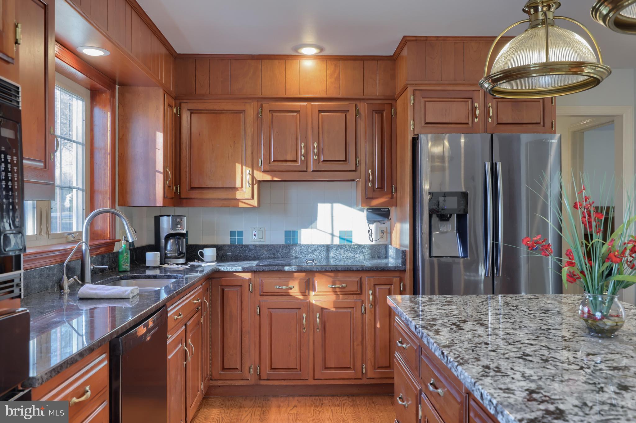 128 Hammersmith Lane Lititz, PA 17543 - Photo 27 of 65 a kitchen with kitchen island granite countertop a sink refrigerator and cabinets
