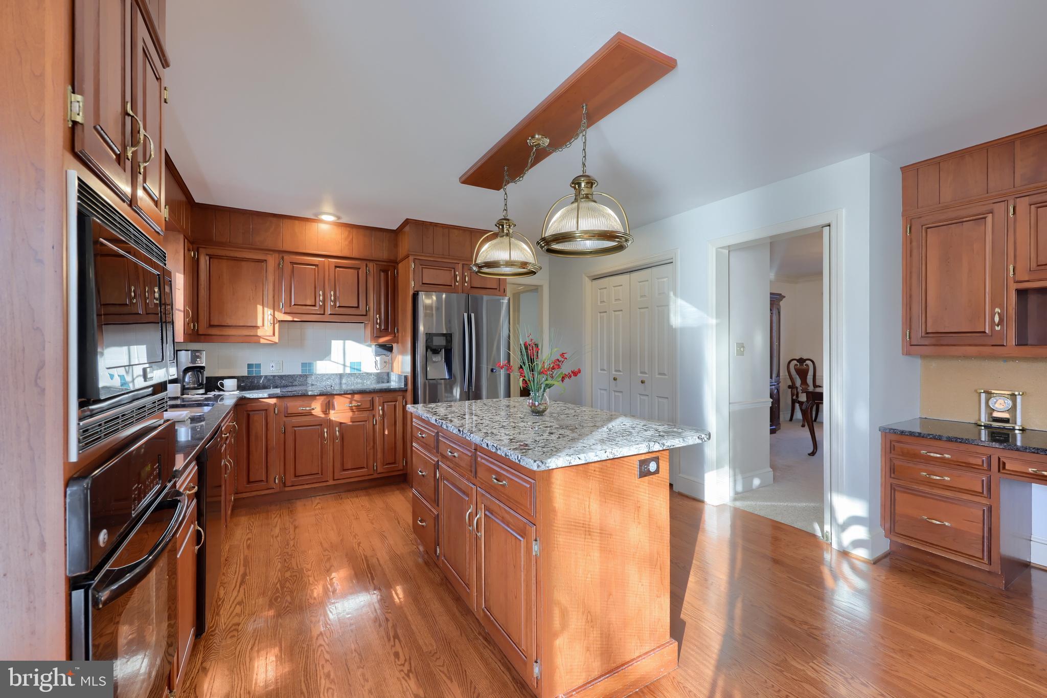 128 Hammersmith Lane Lititz, PA 17543 - Photo 28 of 65 a kitchen with stainless steel appliances granite countertop a stove and a wooden floors