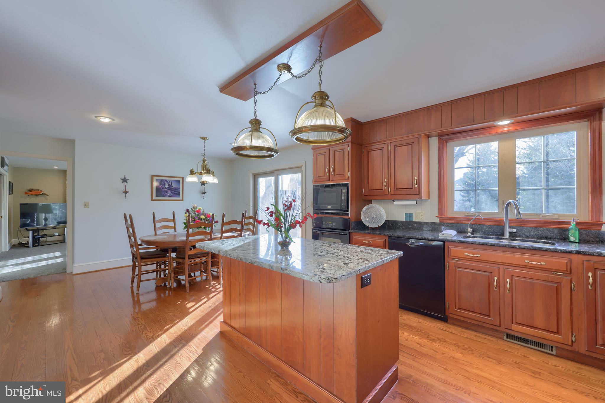 128 Hammersmith Lane Lititz, PA 17543 - Photo 30 of 65 a kitchen with granite countertop a sink a counter top space and living room view