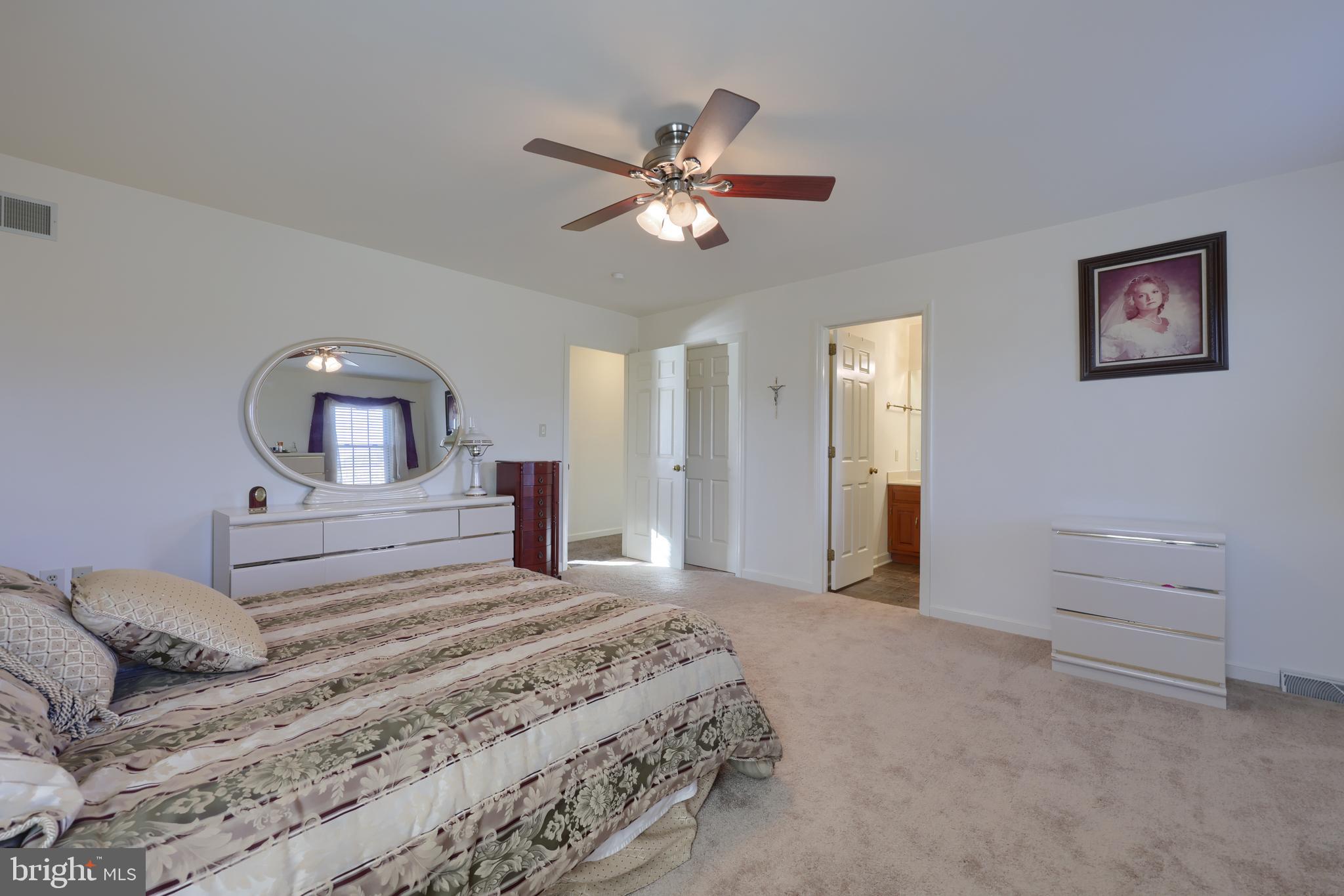 128 Hammersmith Lane Lititz, PA 17543 - Photo 33 of 65 a bedroom with a bed and a chandelier