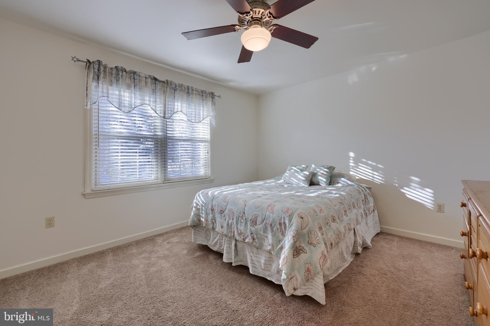 128 Hammersmith Lane Lititz, PA 17543 - Photo 37 of 65 a spacious bedroom with a bed and a chandelier