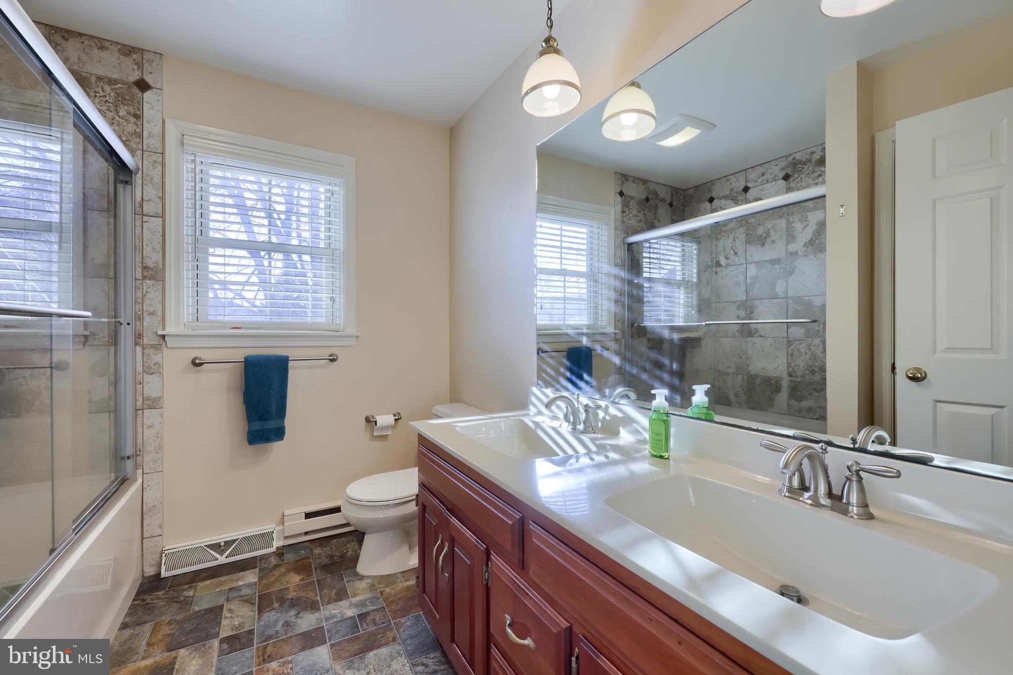 128 Hammersmith Lane Lititz, PA 17543 - Photo 42 of 65 a bathroom with a granite countertop sink a toilet a mirror and shower