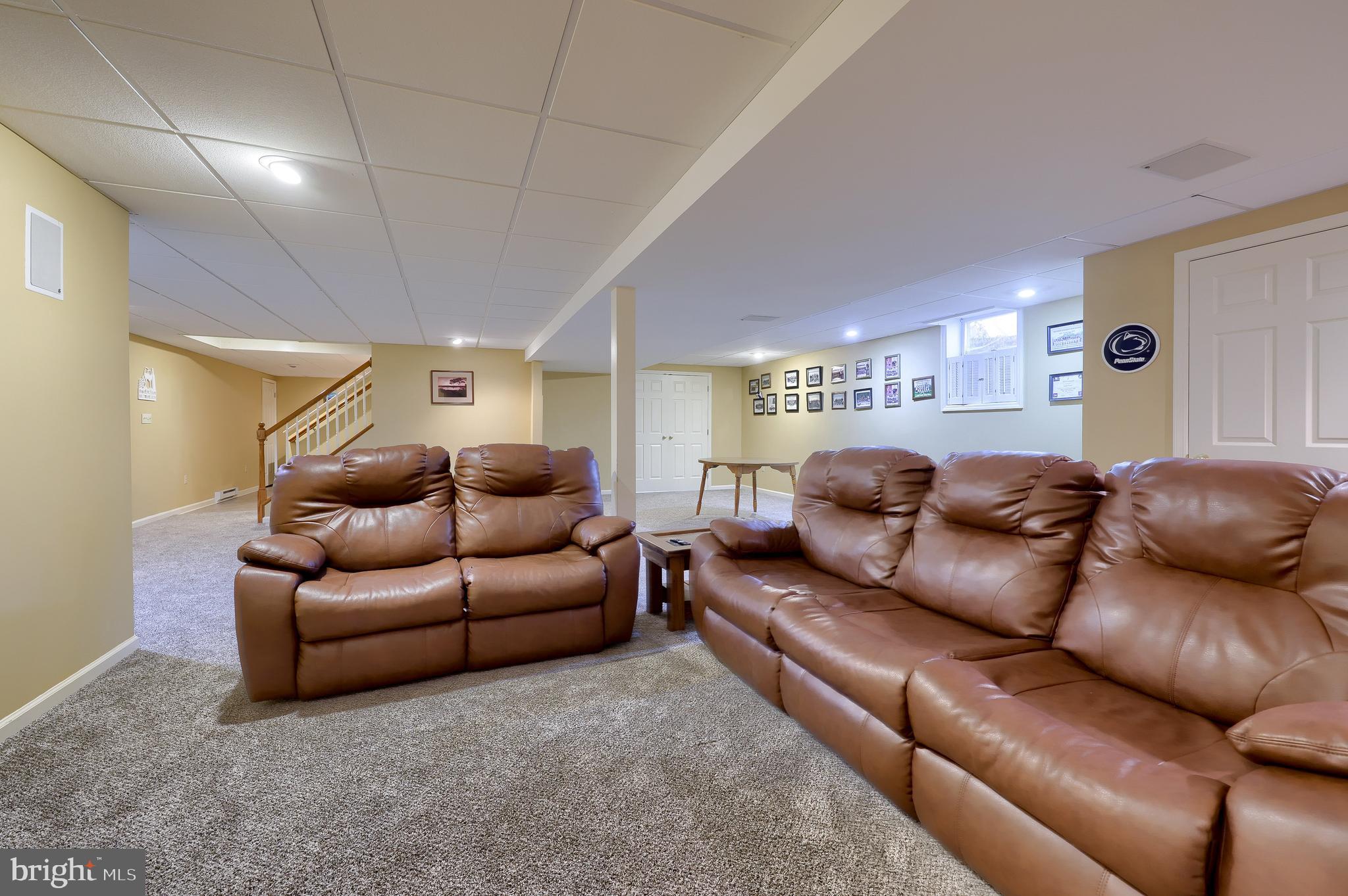 128 Hammersmith Lane Lititz, PA 17543 - Photo 46 of 65 a living room with a couch and a ceiling fan