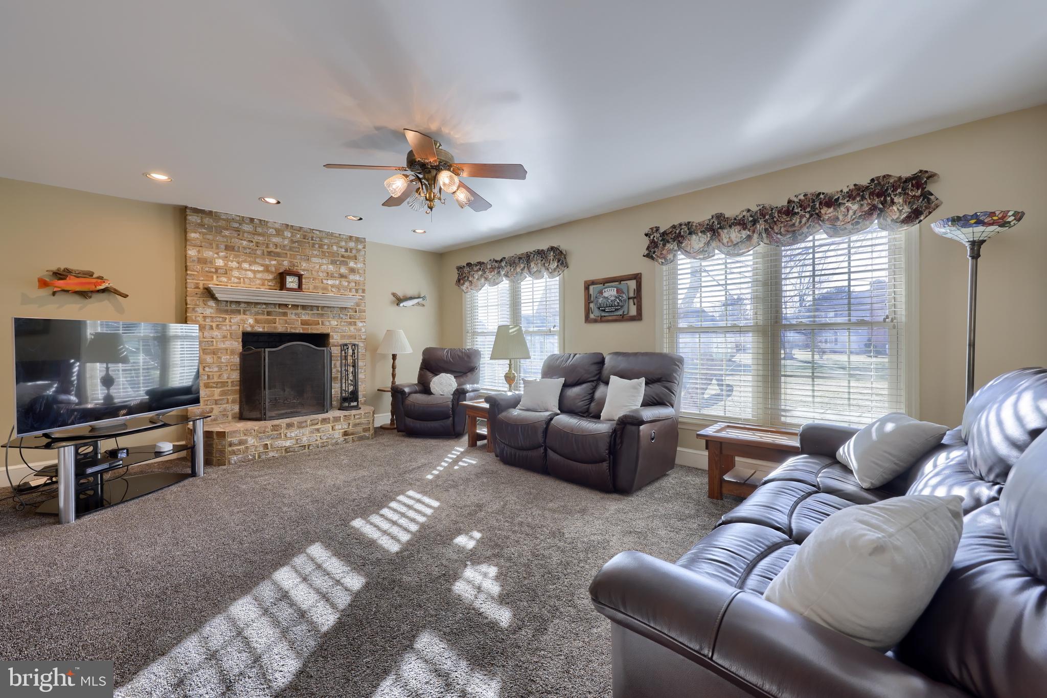 128 Hammersmith Lane Lititz, PA 17543 - Photo 9 of 65 a living room with furniture a flat screen tv and a fireplace