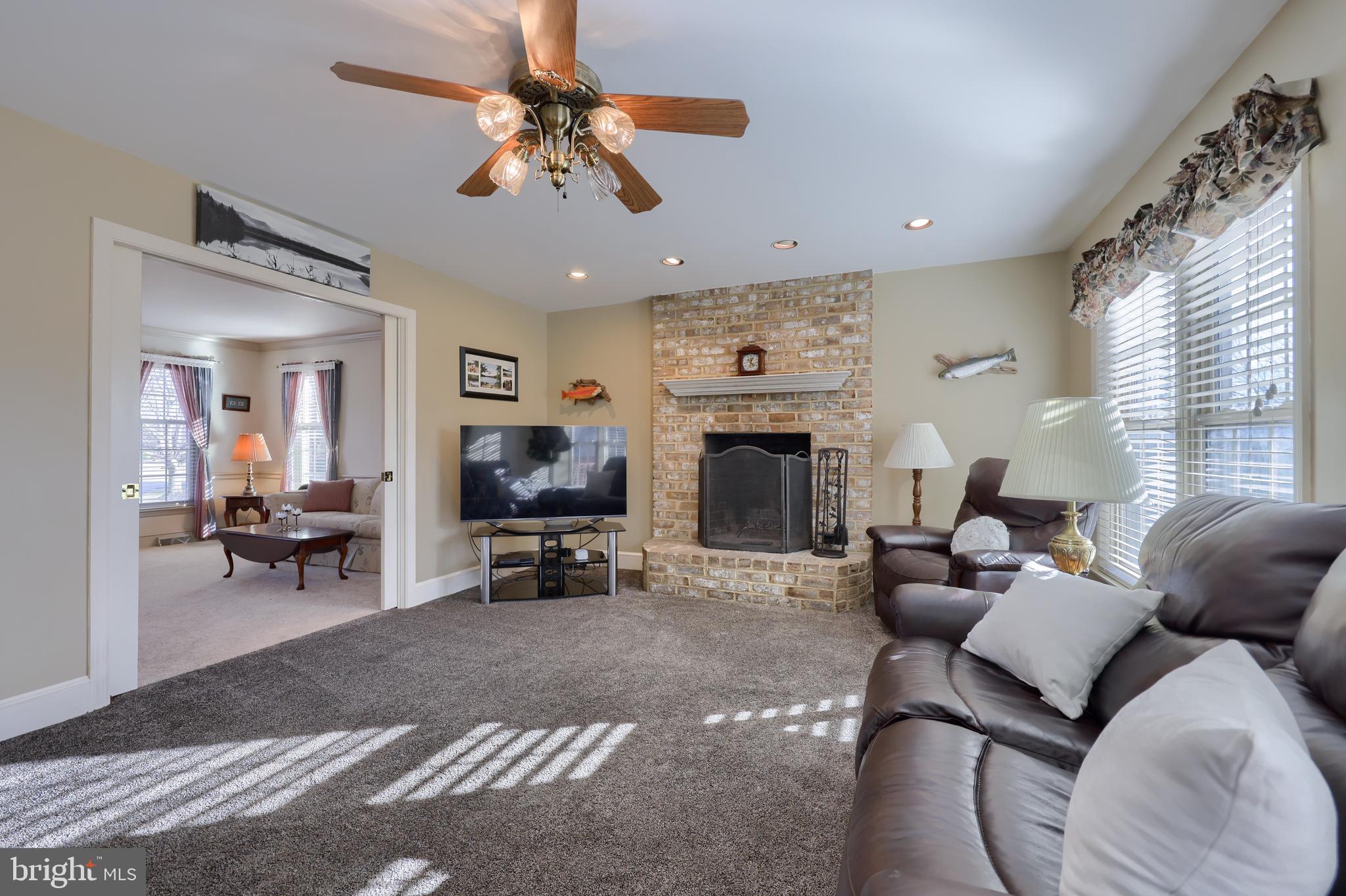 128 Hammersmith Lane Lititz, PA 17543 - Photo 10 of 65 a living room with furniture a fireplace and a flat screen tv