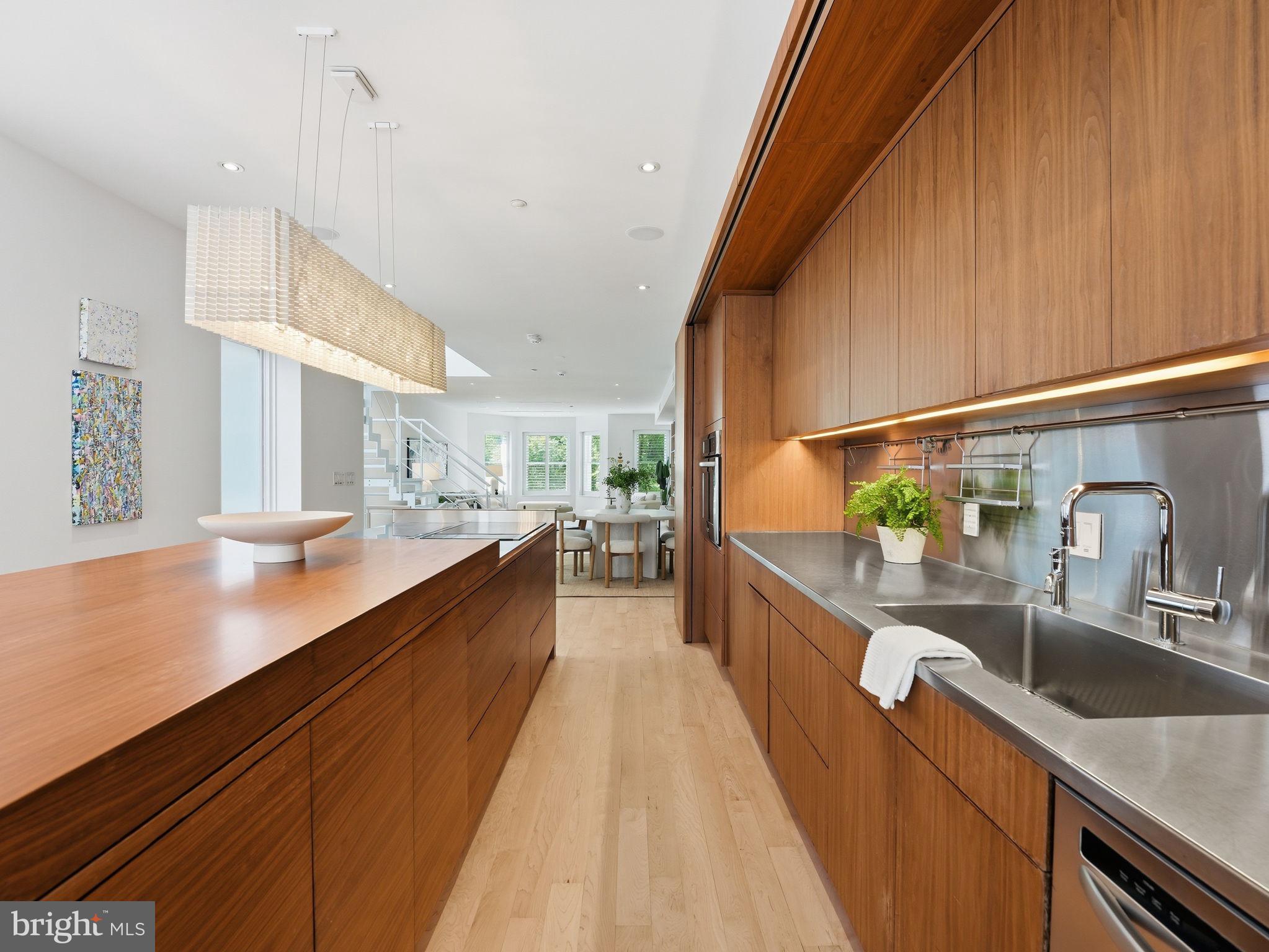 1845 Calvert Street Northwest Washington, DC 20009 - Photo 17 of 48 a large kitchen with kitchen island a large counter space a sink and appliances