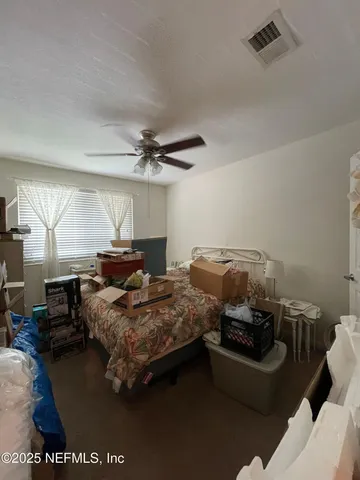 a bedroom with bed and window