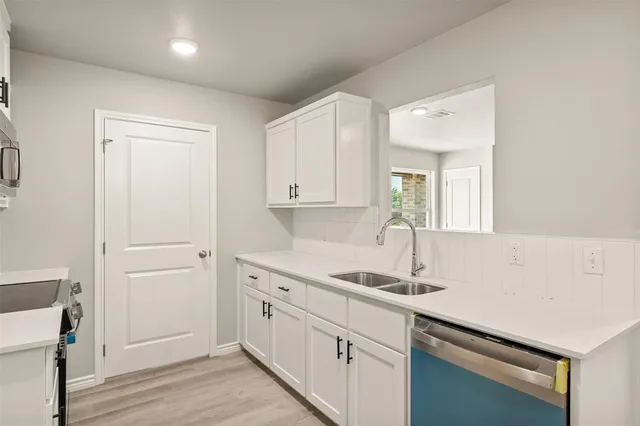 a kitchen with a sink and cabinets