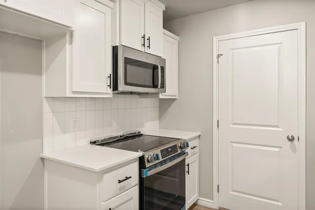 a kitchen with a stove microwave and sink