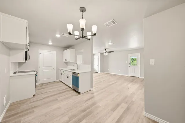a view of a kitchen with a sink and a stove top oven