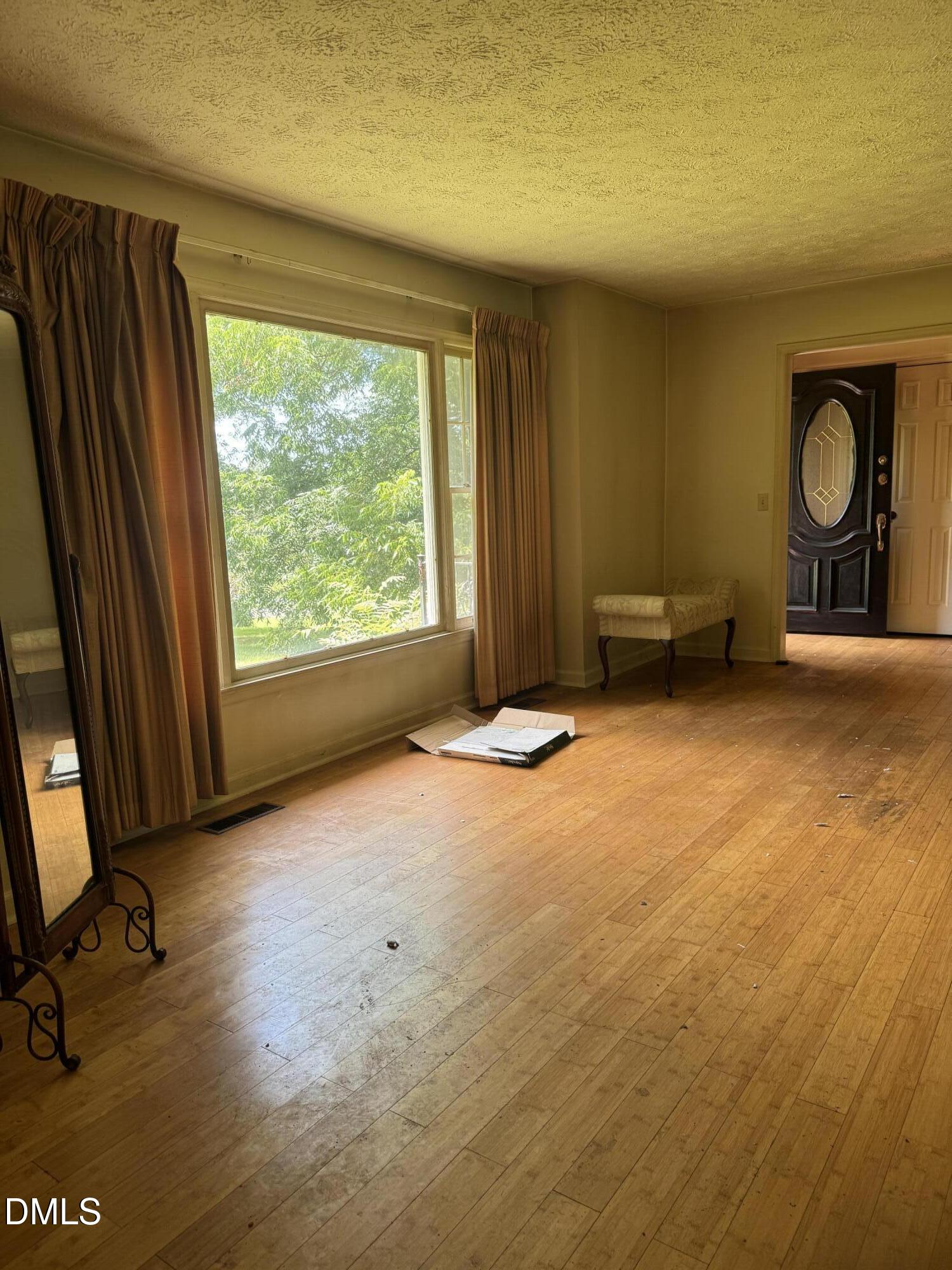 552 Clay Thomas Road Roxboro, NC 27573 - Photo 14 of 18 a view of a livingroom with a fireplace and a window