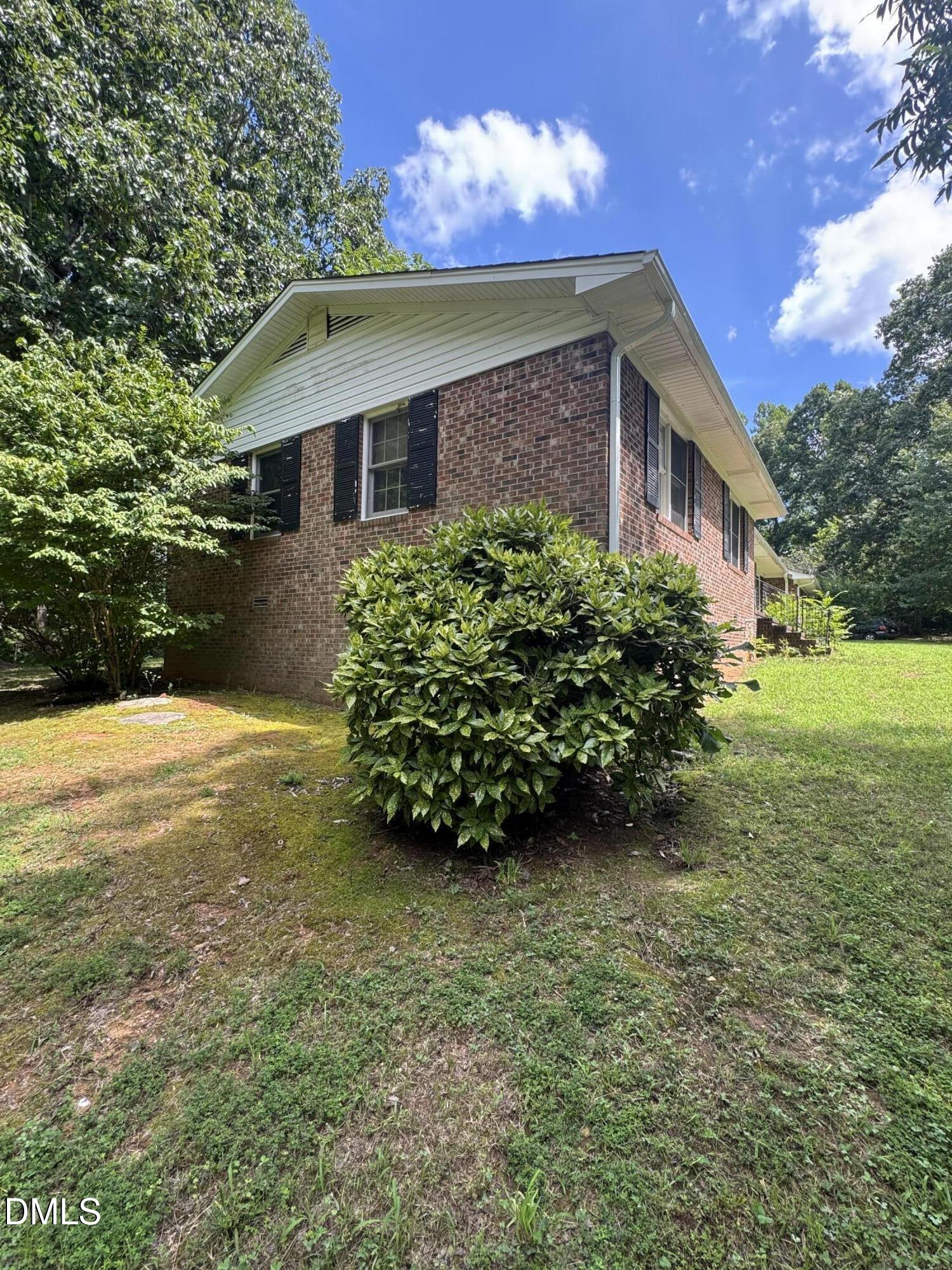 552 Clay Thomas Road Roxboro, NC 27573 - Photo 6 of 18 a view of a house with a yard