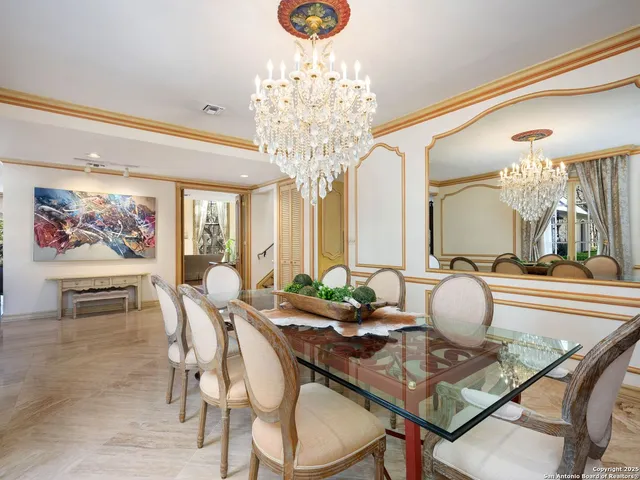 a kitchen with a table chairs and a wooden floor
