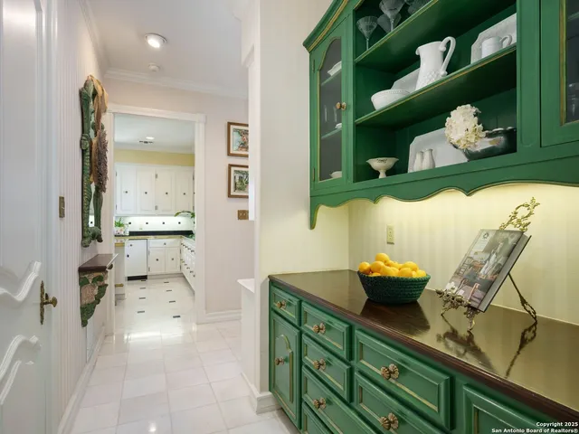 a kitchen with stainless steel appliances kitchen island granite countertop a sink a stove and white cabinets