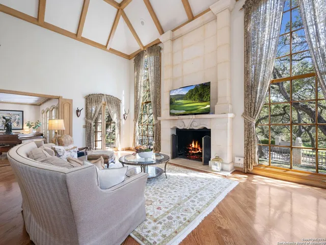 a living room with furniture fireplace and window