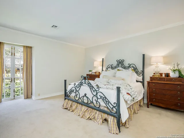 a view of a dining room with furniture chandelier and a window