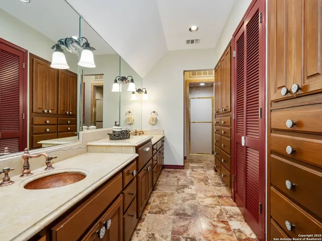 a view of a lake with a bench next to yard