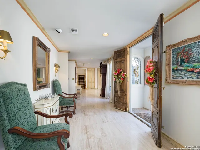 a living room with fireplace furniture and a large window
