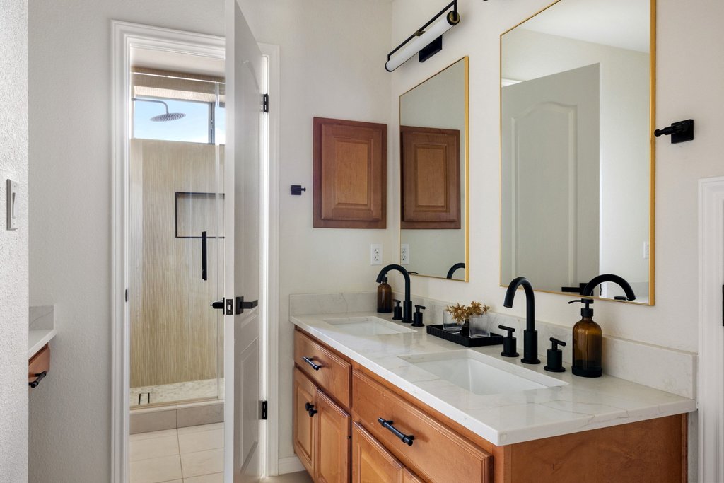 6704 Kiev Cove Austin, TX 78739 - Photo 29 of 37 Double vanity with sleek fixtures provides ample space and elegant style in this well-appointed bathroom.