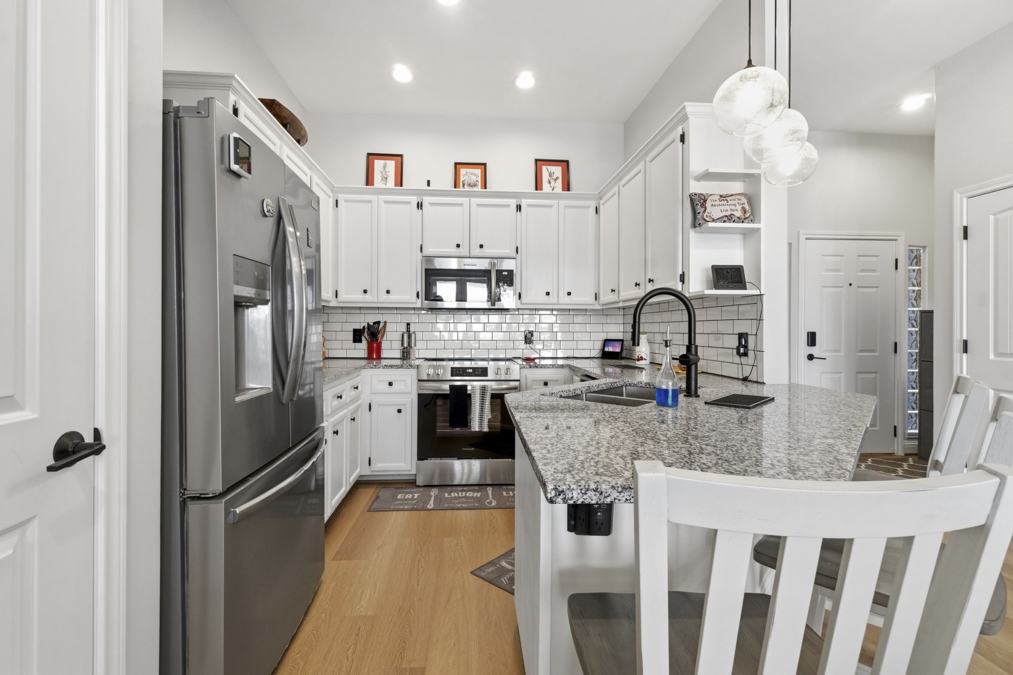 2 Key Harbour Conroe, TX 77356 - Photo 12 of 41 a kitchen with stainless steel appliances granite countertop a refrigerator and a sink