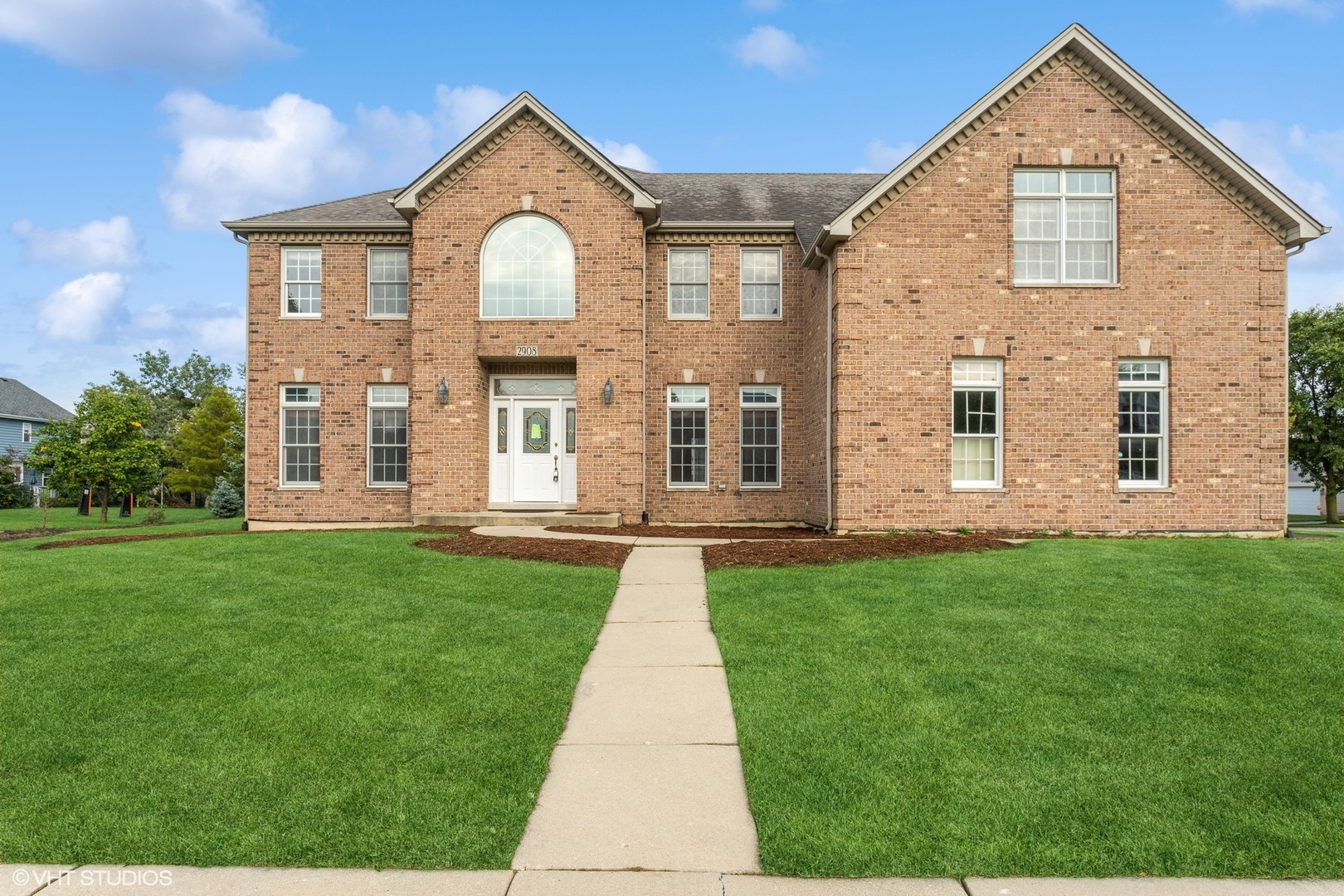 a front view of a house with a yard